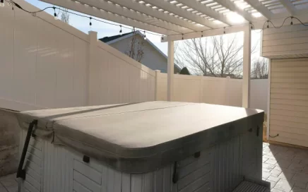 square outdoor hot tub covered with beige tarp pool cover